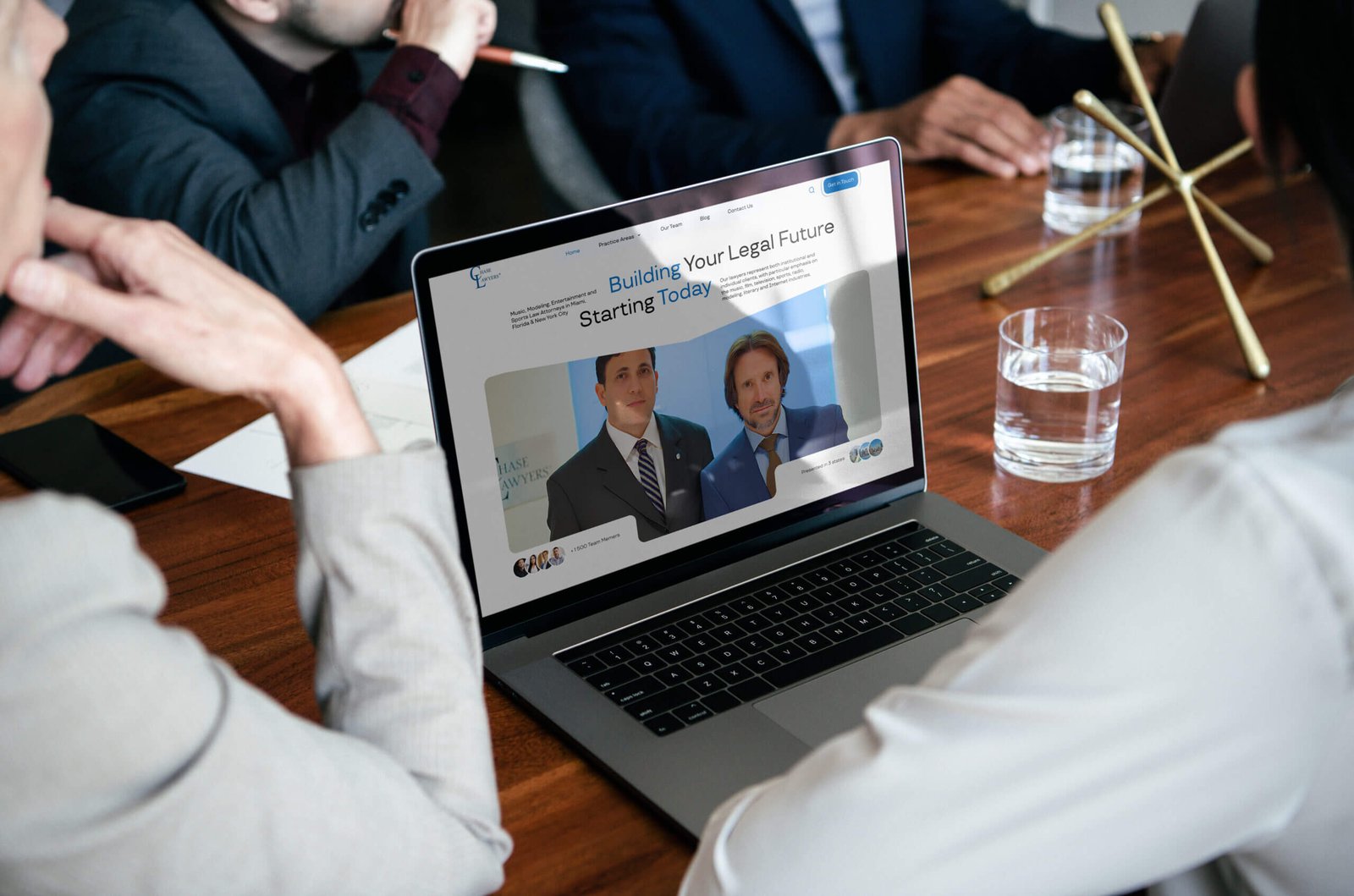 Business people using a laptop screen mockup in a meeting